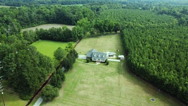 birds eye view of property with a view of trees