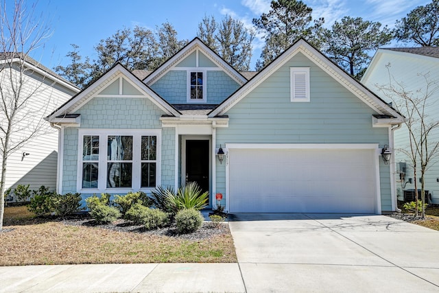 craftsman house featuring central air condition unit, driveway, and a garage