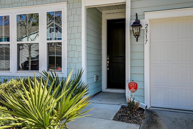 doorway to property with a garage