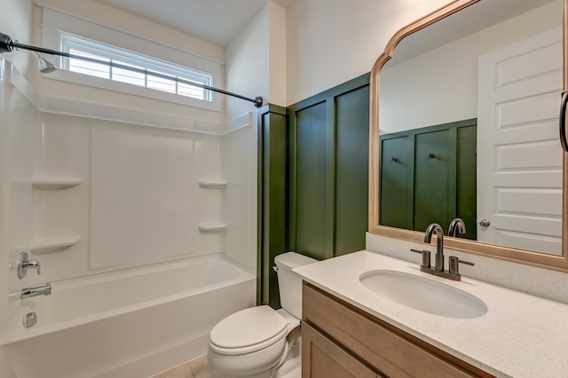 bathroom featuring toilet, wainscoting, a decorative wall, vanity, and  shower combination