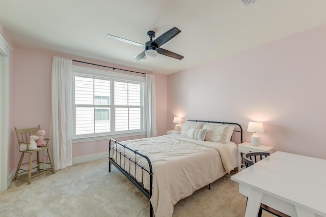 bedroom with light colored carpet, a ceiling fan, and baseboards