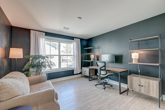 office space featuring visible vents, baseboards, and wood finished floors