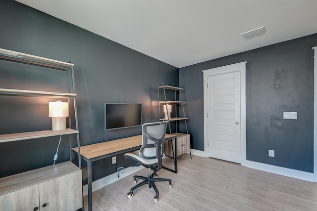 office featuring visible vents, baseboards, and wood finished floors