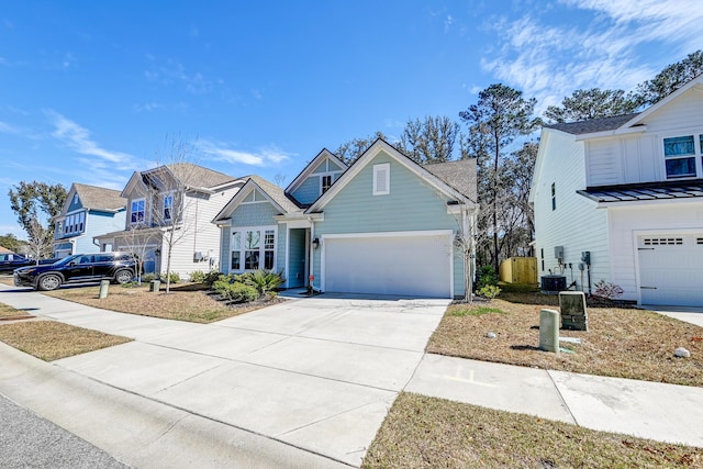 view of front of property featuring a garage, central AC, and concrete driveway