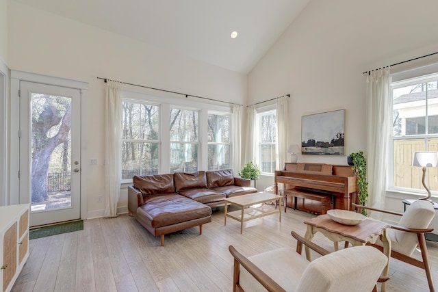 sitting room featuring recessed lighting, light wood-type flooring, and high vaulted ceiling