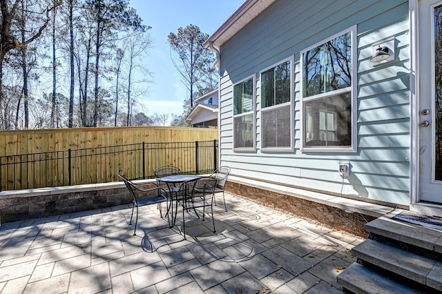 view of patio / terrace featuring outdoor dining area and fence