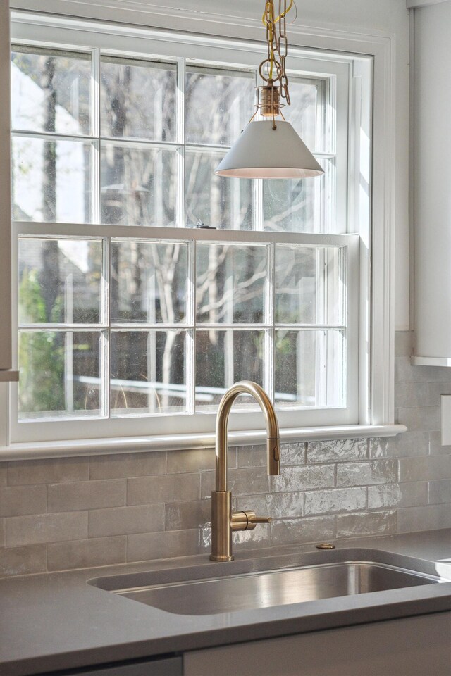 room details with tasteful backsplash and a sink