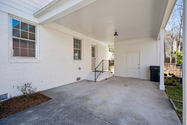 view of patio with a carport and fence