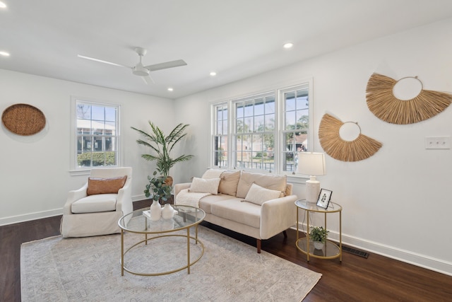 living area featuring dark wood finished floors, visible vents, recessed lighting, and baseboards