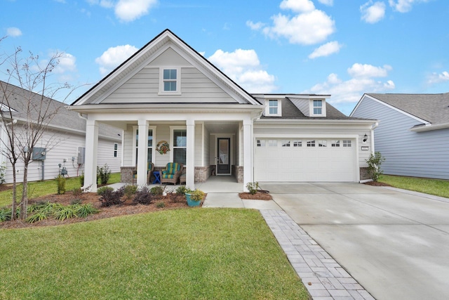 view of front facade featuring a front yard, a porch, and a garage