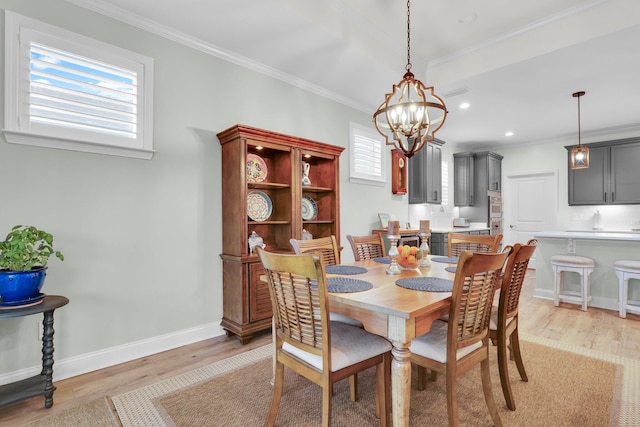 dining area featuring an inviting chandelier, light hardwood / wood-style flooring, and crown molding