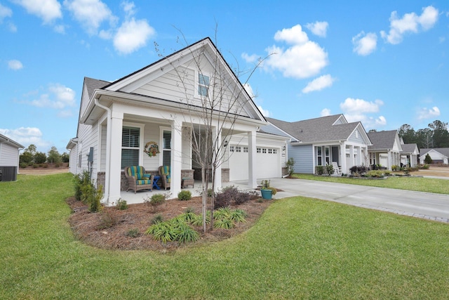 view of front of house featuring a porch, a garage, a front yard, and cooling unit