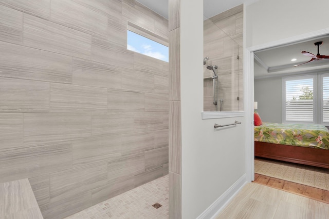 bathroom featuring ceiling fan and tiled shower