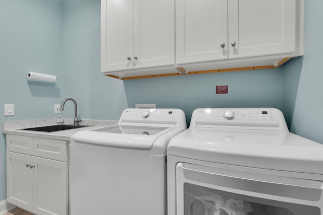 laundry area with cabinets, sink, and washing machine and dryer