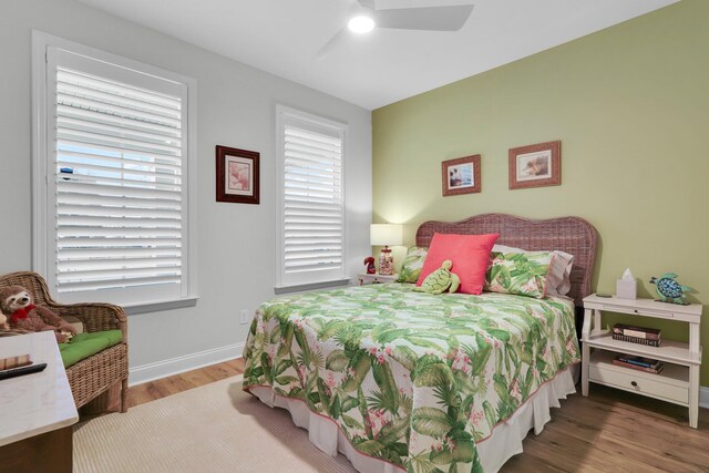 bedroom with ceiling fan and wood-type flooring