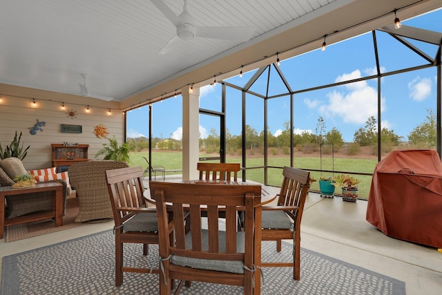 sunroom / solarium featuring ceiling fan