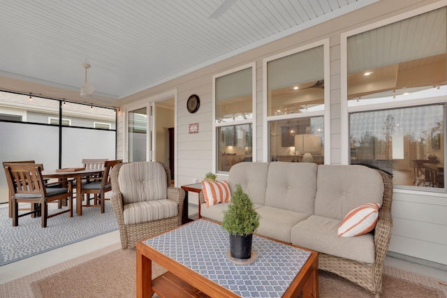 sunroom featuring ceiling fan