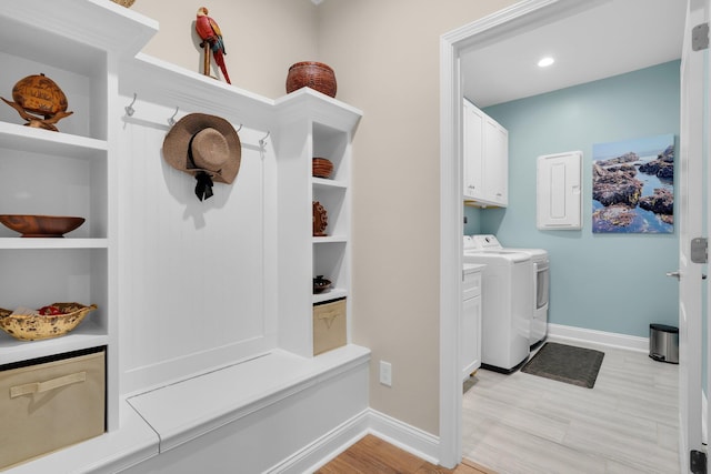 mudroom featuring electric panel and washer and clothes dryer