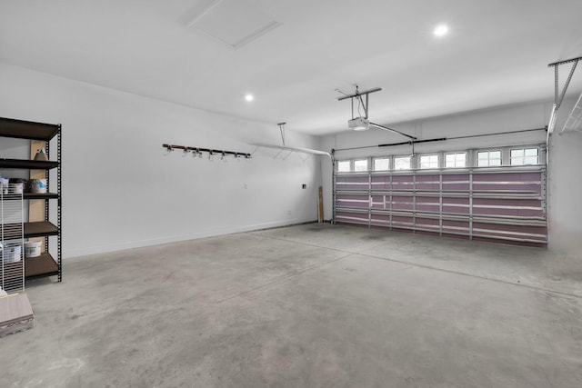 garage featuring recessed lighting, baseboards, and a garage door opener