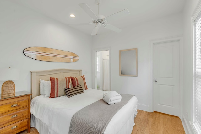 bedroom featuring recessed lighting, a ceiling fan, baseboards, light wood finished floors, and ensuite bath