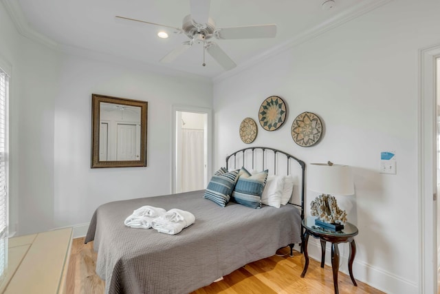 bedroom with light wood-type flooring, baseboards, ornamental molding, and a ceiling fan