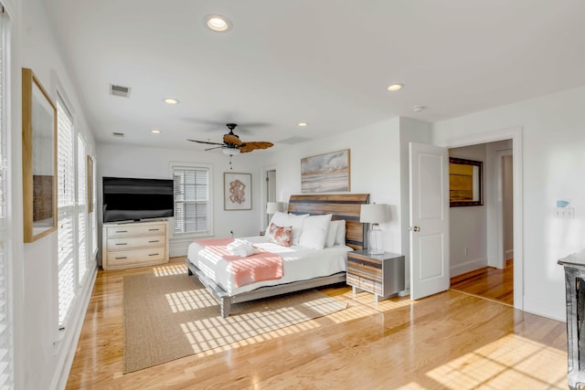 bedroom featuring recessed lighting, visible vents, ceiling fan, light wood-type flooring, and baseboards