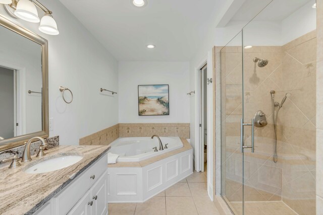 full bath with a stall shower, vanity, a bath, and tile patterned floors