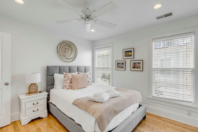 bedroom featuring recessed lighting, visible vents, light wood-style floors, a ceiling fan, and baseboards