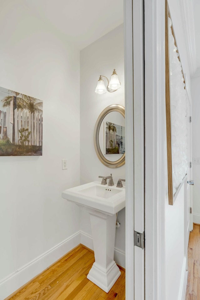 bathroom with wood finished floors and baseboards