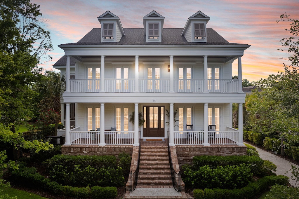 view of front facade featuring a balcony and a porch