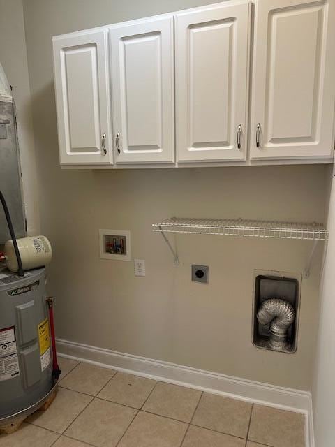 washroom with light tile patterned floors, electric water heater, baseboards, cabinet space, and electric dryer hookup