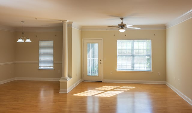 entryway featuring ornamental molding, light wood-type flooring, and decorative columns