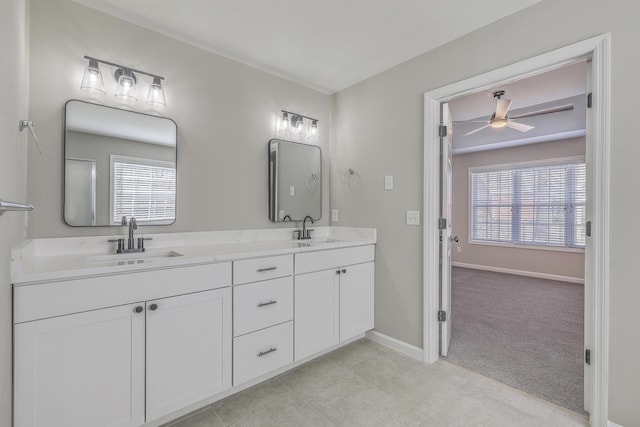 full bathroom featuring a wealth of natural light, ceiling fan, and a sink