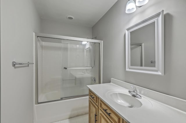 bathroom featuring combined bath / shower with glass door, vanity, and tile patterned floors