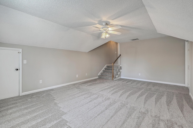 bonus room with lofted ceiling, carpet, stairs, and visible vents