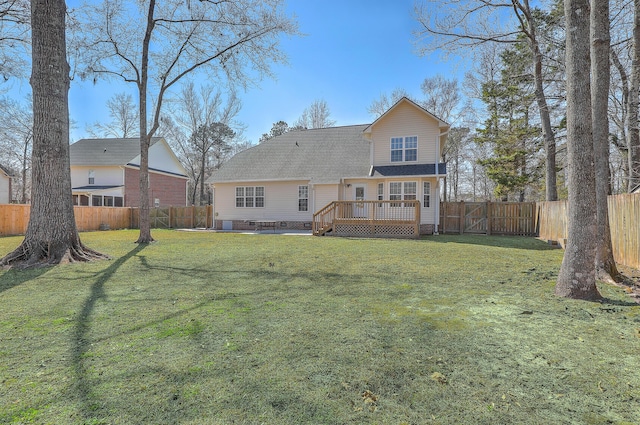 back of property with a fenced backyard, a lawn, crawl space, a wooden deck, and a gate