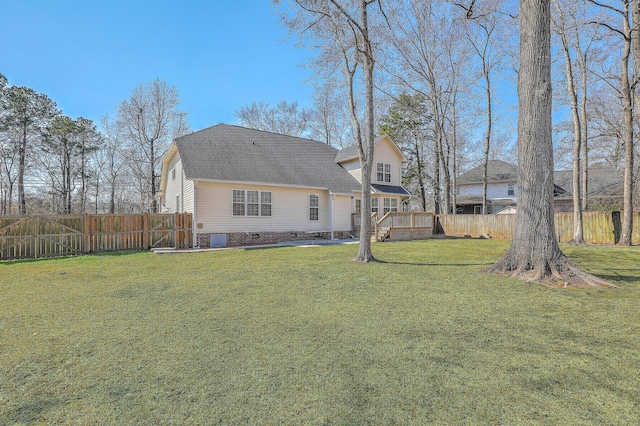 rear view of house with a deck, a yard, crawl space, and fence