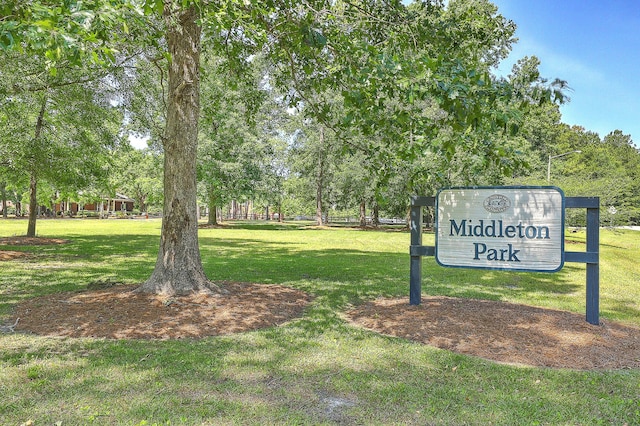 view of property's community with a lawn