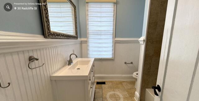 bathroom featuring tile patterned floors, vanity, and toilet