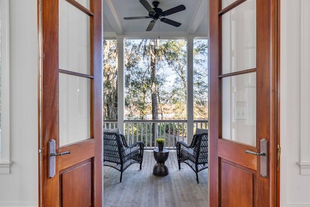 sunroom / solarium with a wealth of natural light and ceiling fan