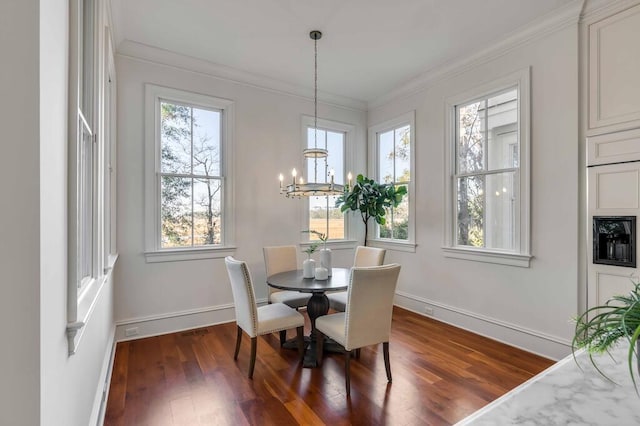 dining space with a notable chandelier, ornamental molding, dark wood finished floors, and baseboards