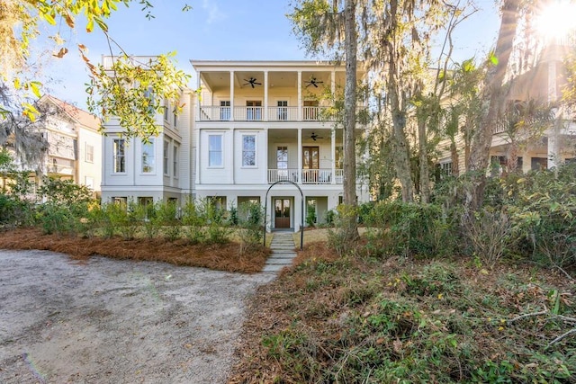 view of front of home with a balcony and ceiling fan