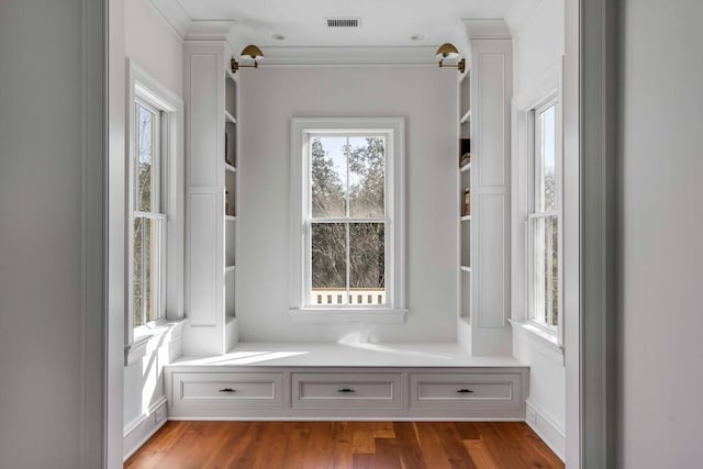 mudroom featuring visible vents, crown molding, and light wood-style flooring