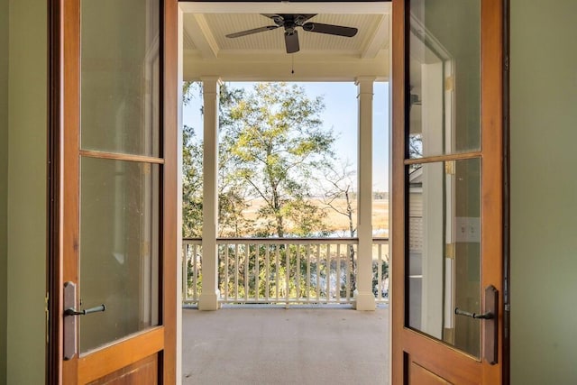 doorway to outside with a healthy amount of sunlight, carpet, and ceiling fan