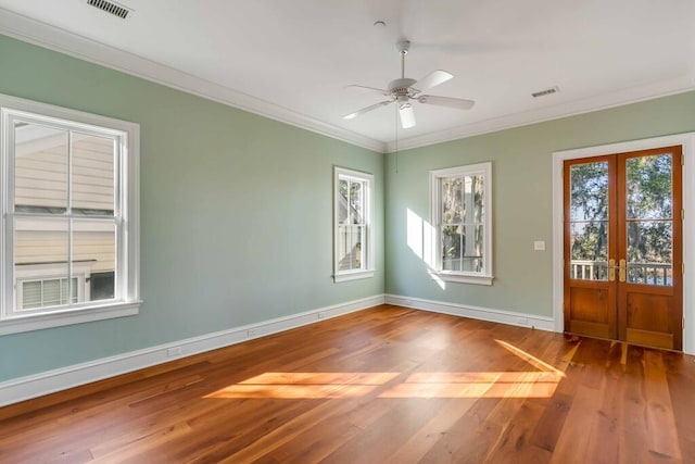 foyer entrance featuring baseboards, visible vents, ornamental molding, wood finished floors, and french doors