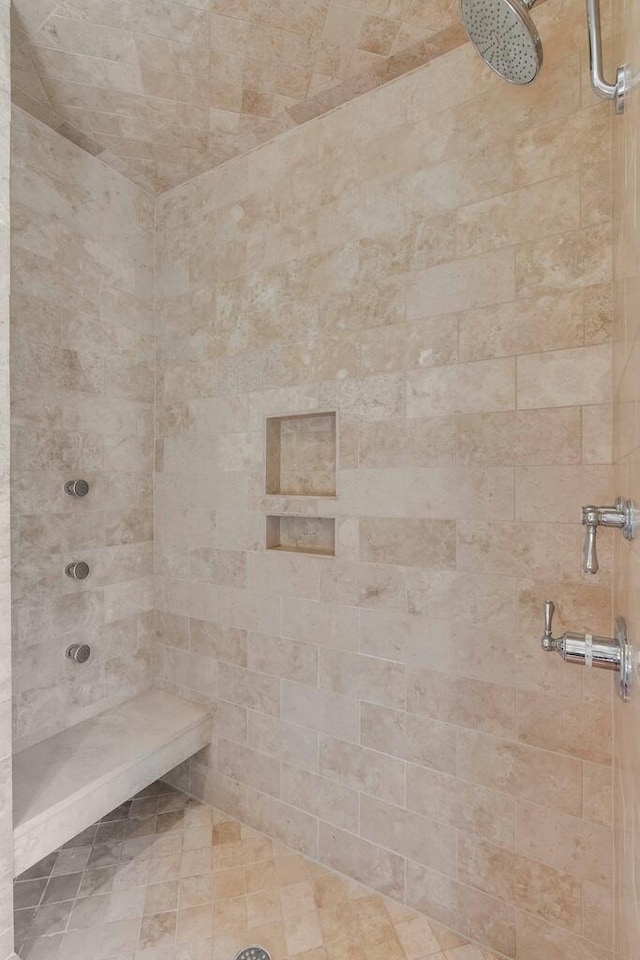 full bath with a tile shower