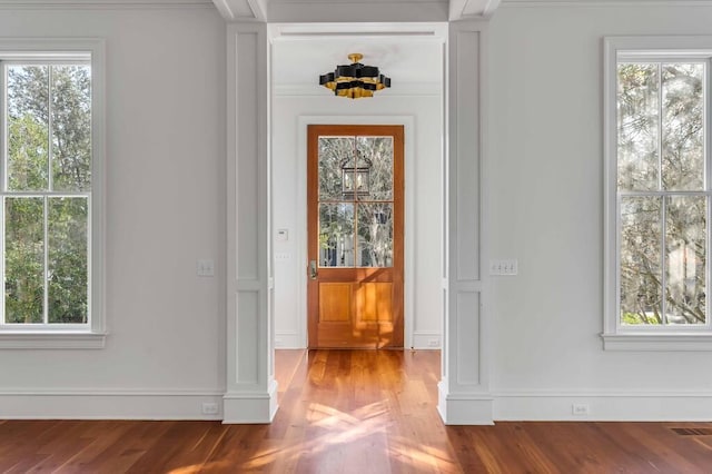 interior space featuring light wood finished floors, plenty of natural light, and visible vents