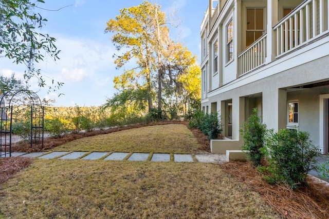 view of yard with a balcony