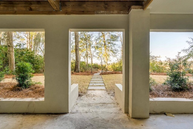 entryway with plenty of natural light and unfinished concrete floors