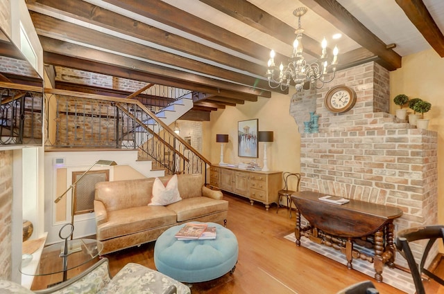 living room with beamed ceiling, hardwood / wood-style floors, and a notable chandelier